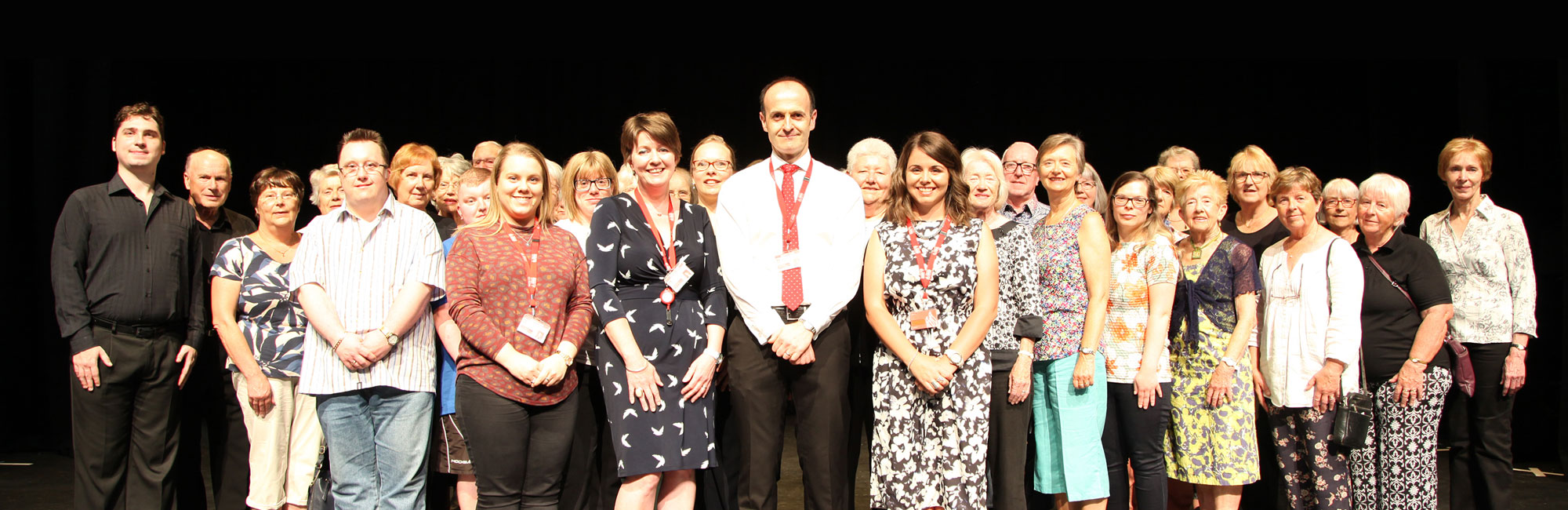 The Torch Theatre volunteer team together on stage