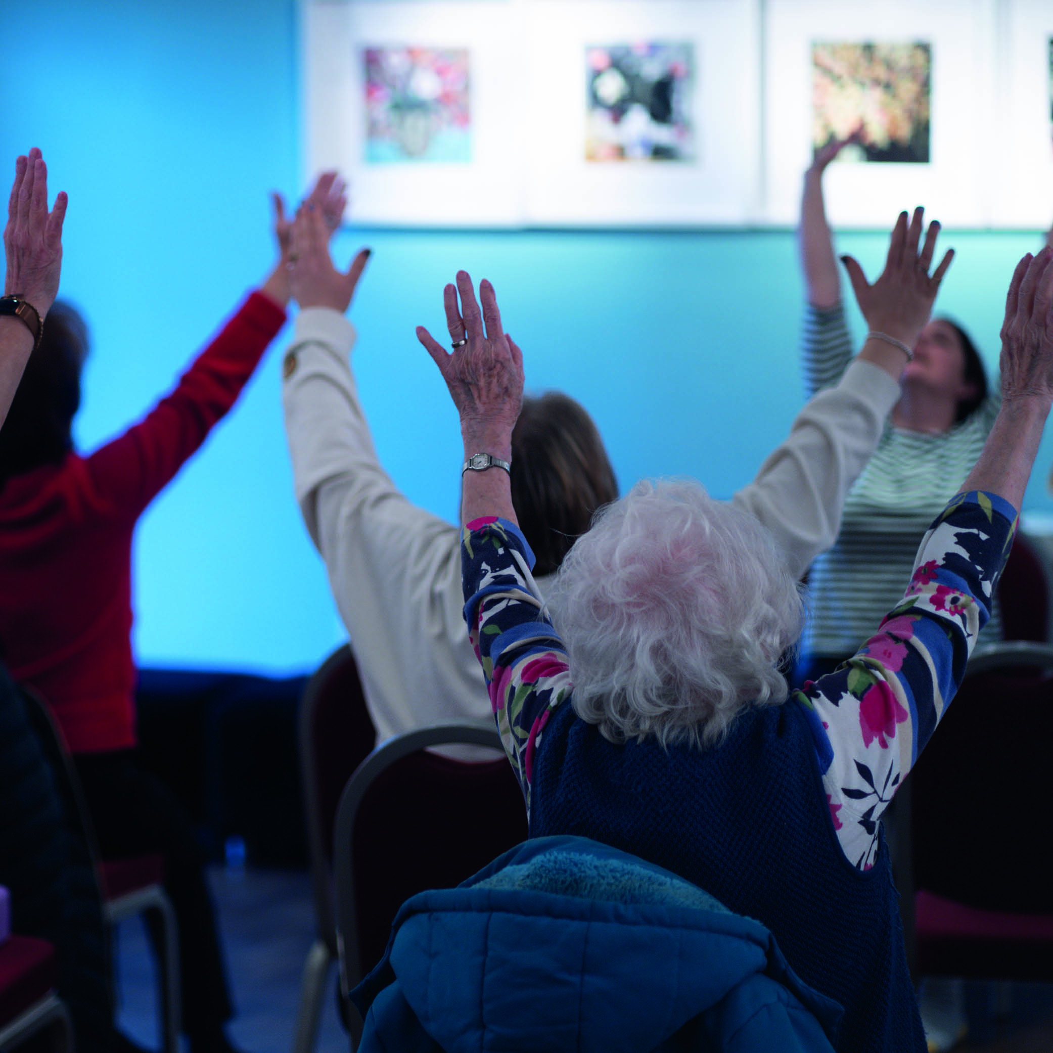 Participants raising their hands during a community session